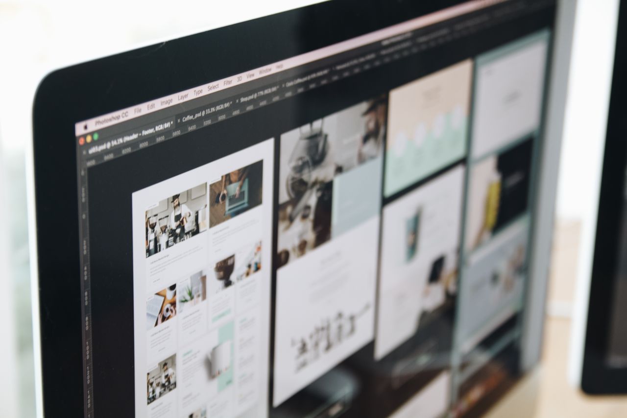 A contemporary computer display showing web design work, highlighting creative visuals in a workspace.